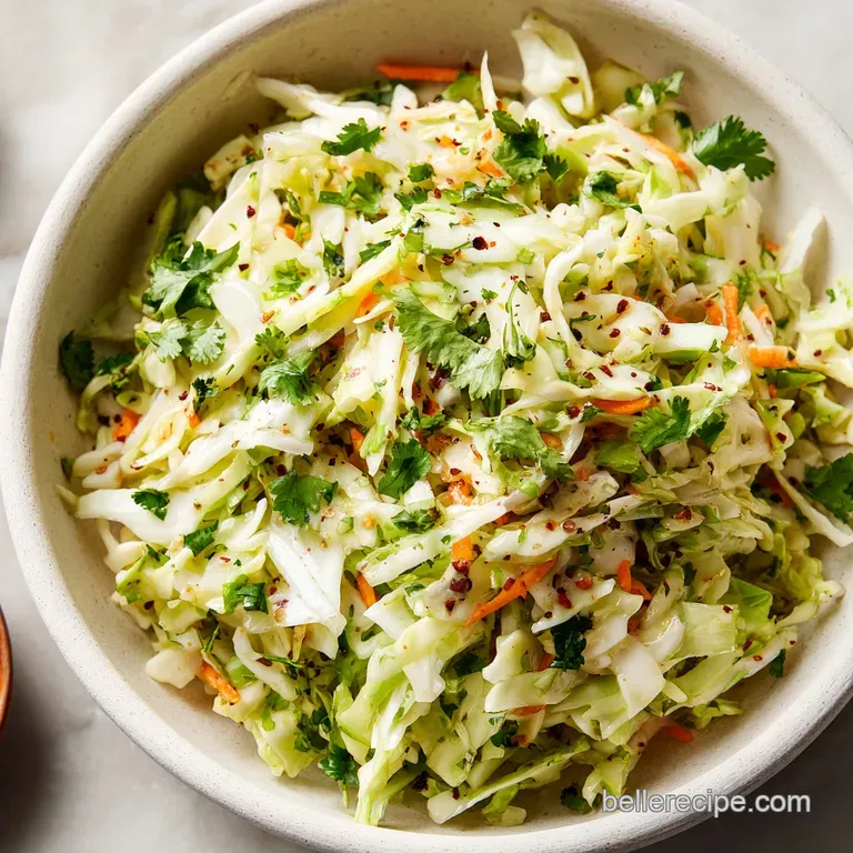 Bright cilantro-lime slaw overflowing from a warm taco shell, garnished with extra lime wedges and a sprinkle of cilantro.