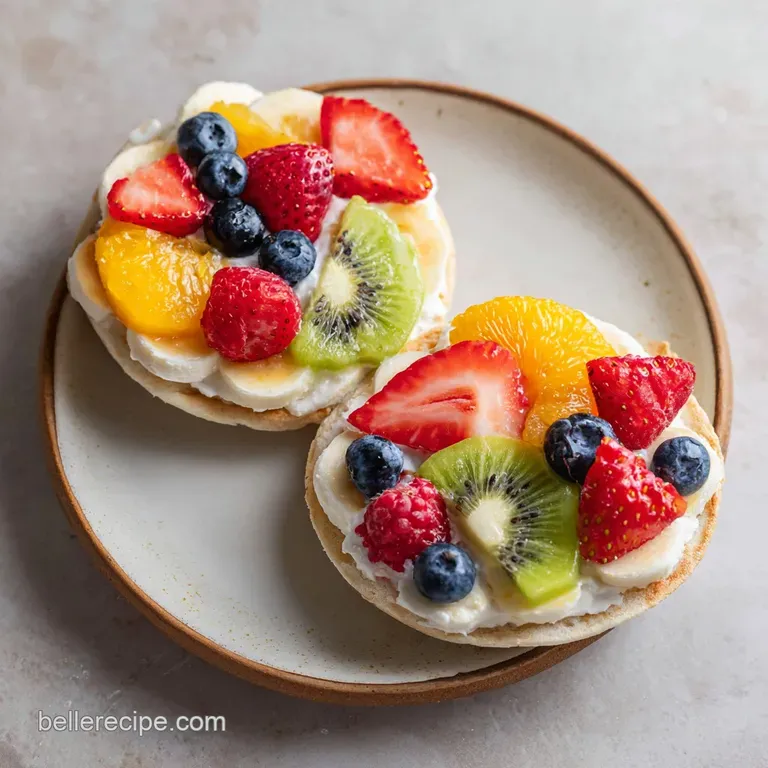 Individual Easter egg fruit pizza, a colorful dessert, sits on a plate. Shiny fruit contrast with creamy frosting.