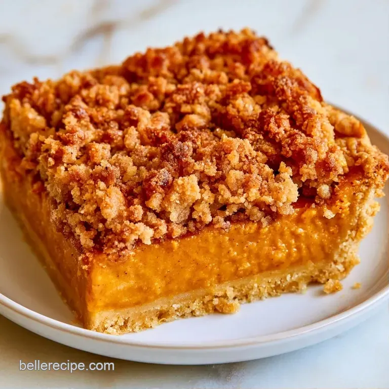 A scoop of vanilla ice cream melting over a warm slice of pumpkin crumble on a clean white plate with mint garnish