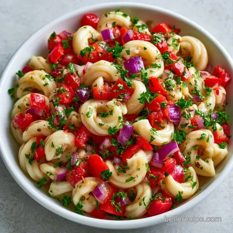 Chilled creamy pasta salad served in a modern glass bowl, topped with a sprig of fresh parsley and cracked black pepper.