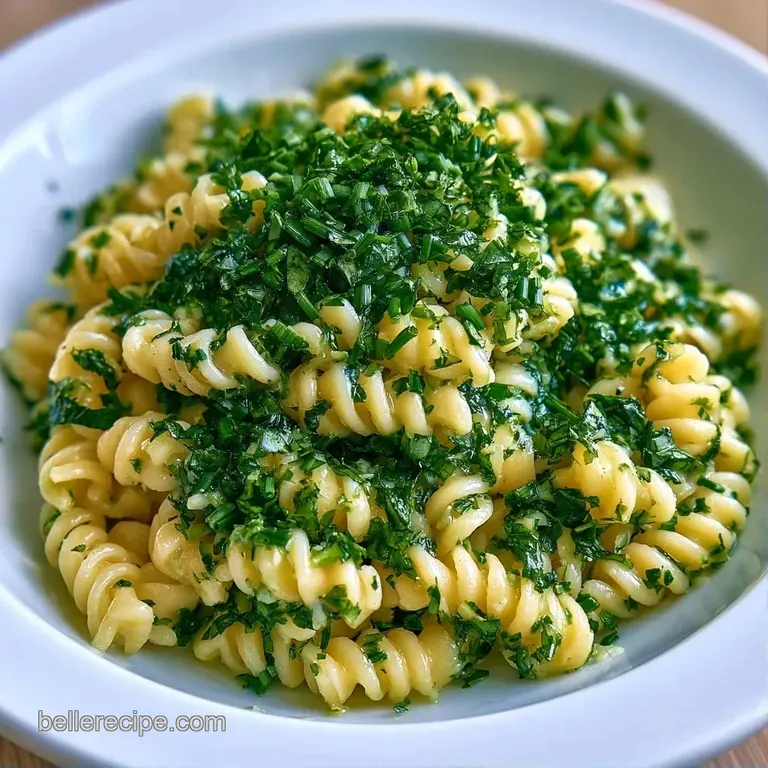 Elegant white platter of chilled pasta spirals garnished with fresh mint leaves and a dusting of cracked pepper.