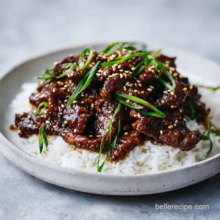 Sliced charred beef with a glossy glaze, garnished with fresh scallions and thin slices of pale Asian pear.