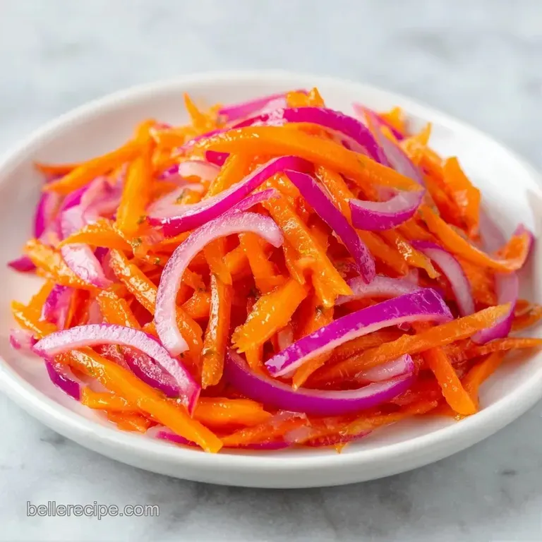 Bright orange carrot batons and slivered red onions arranged in a glass jar with peppercorns and fresh dill.
