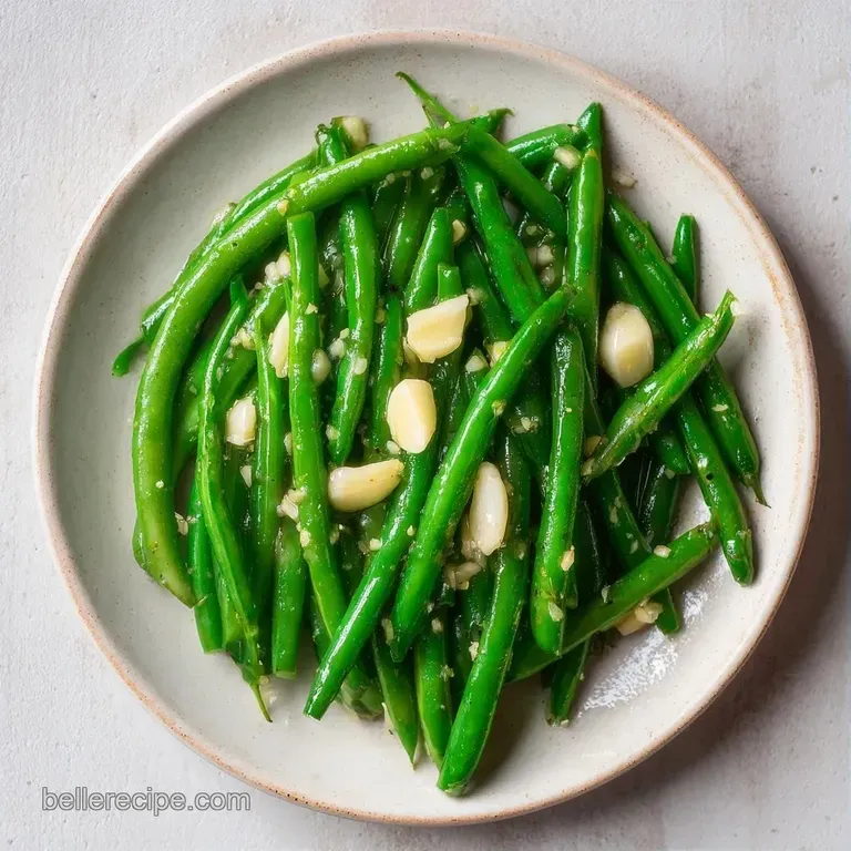 A chilled glass mason jar filled with bright green beans and aromatic dill, set against a rustic white backdrop.