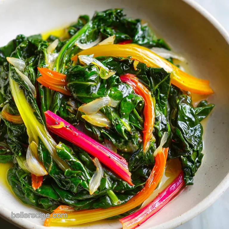 Plated Swiss chard: Glossy, dark green leaves contrast with golden saut&eacute;ed garlic, creating an inviting, healthy meal.