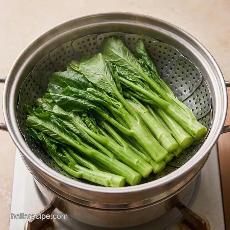 Bright green steamed Chinese broccoli in a steamer basket.