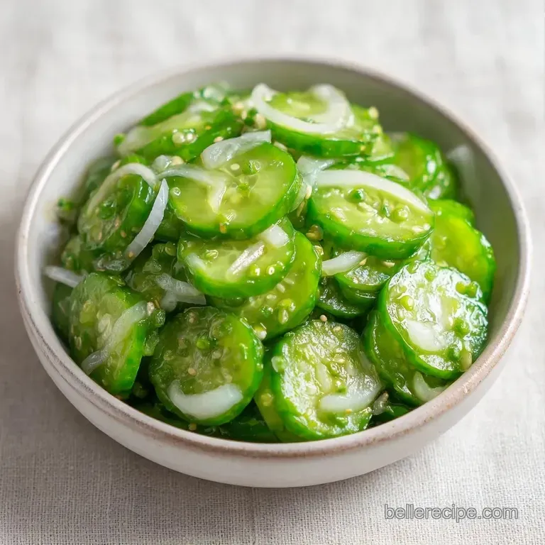 Bright green cucumber rounds arranged on a white platter next to a small bowl of creamy dipping sauce.